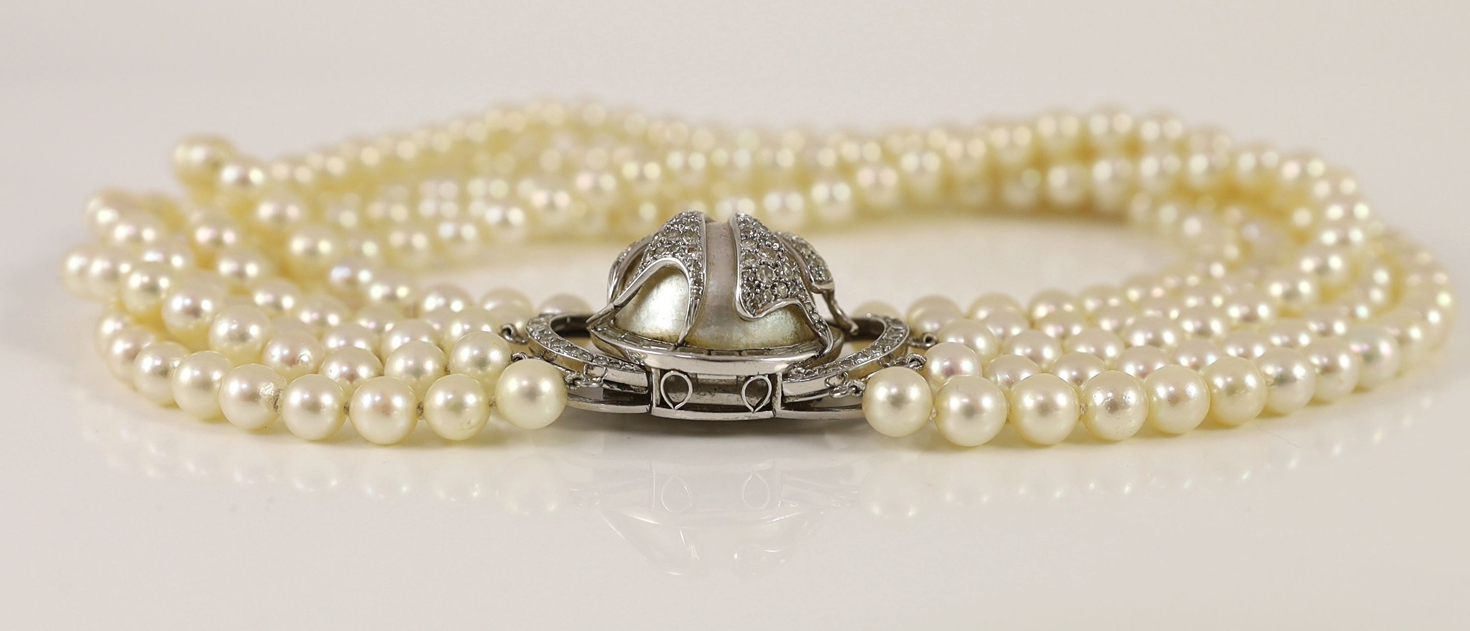 A 20th century quintuple strand cultured pearl choker necklace, with 14k, white gold and diamond set large mabe pearl clasp